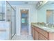 Bathroom features double sinks and a glass enclosed shower, with views to bedroom at 10144 Arbor Run Dr # 122, Tampa, FL 33647