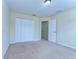 Comfortable bedroom featuring a closet, a neutral carpet, and an open doorway at 10144 Arbor Run Dr # 122, Tampa, FL 33647