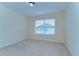 Bright bedroom with neutral carpet and a window providing natural light at 10144 Arbor Run Dr # 122, Tampa, FL 33647