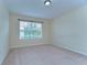 Cozy bedroom with neutral carpet, a large window, and plenty of natural light at 10144 Arbor Run Dr # 122, Tampa, FL 33647