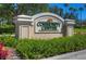 Community center sign surrounded by manicured landscaping, showcasing neighborhood amenities at 10144 Arbor Run Dr # 122, Tampa, FL 33647