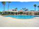 Luxurious community pool with ample seating, pergolas, and landscaping, perfect for relaxation at 10144 Arbor Run Dr # 122, Tampa, FL 33647
