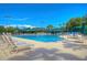 A sparkling community pool features lounge chairs, tables, and umbrellas, creating an inviting resort-style atmosphere at 10144 Arbor Run Dr # 122, Tampa, FL 33647