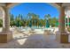 Stunning view of the community pool framed by elegant columns and archways, surrounded by lush landscaping at 10144 Arbor Run Dr # 122, Tampa, FL 33647