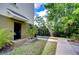 Inviting front entrance with black door, lush tropical landscaping and a sidewalk at 10144 Arbor Run Dr # 122, Tampa, FL 33647