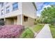 A townhome exterior featuring beige walls, garage and landscaped sidewalk at 10144 Arbor Run Dr # 122, Tampa, FL 33647