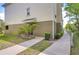 Side exterior view showcasing the building's architecture, with a pathway and minimal landscaping at 10144 Arbor Run Dr # 122, Tampa, FL 33647