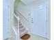 Bright foyer with tile flooring, a white front door, and a staircase leading to the upper level at 10144 Arbor Run Dr # 122, Tampa, FL 33647
