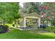 An outdoor gazebo is surrounded by mature trees and lush green space at 10144 Arbor Run Dr # 122, Tampa, FL 33647