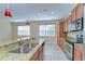 Granite countertops, stainless appliances, and recessed lighting complement this modern kitchen at 10144 Arbor Run Dr # 122, Tampa, FL 33647