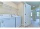 Convenient laundry room with washer, dryer, and shelving at 10144 Arbor Run Dr # 122, Tampa, FL 33647