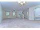 Expansive living room featuring carpet floors, bright windows, a ceiling fan and staircase access at 10144 Arbor Run Dr # 122, Tampa, FL 33647