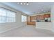 Bright living room flows into a modern kitchen featuring tile floors and stainless steel appliances at 10144 Arbor Run Dr # 122, Tampa, FL 33647