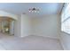 Bright and open living room with an archway to the stairs and large window at 10144 Arbor Run Dr # 122, Tampa, FL 33647