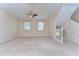 Open living room with neutral walls, carpet flooring, and staircase access at 10144 Arbor Run Dr # 122, Tampa, FL 33647