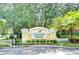 Well maintained community signage with manicured shrubs and flowering plants at 10144 Arbor Run Dr # 122, Tampa, FL 33647
