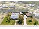 Aerial view of a canal-front home featuring a pool and tropical landscaping at 112 Gause Dr, Venice, FL 34293