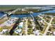 An aerial view displays the home's placement in a serene neighborhood on the water at 112 Gause Dr, Venice, FL 34293