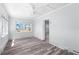 Bright bedroom showcases wood floors, large window, and light blue walls, creating a serene atmosphere at 112 Gause Dr, Venice, FL 34293