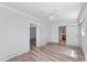 Spacious bedroom boasts wood-look floors, a cooling ceiling fan, and access to a convenient ensuite bathroom at 112 Gause Dr, Venice, FL 34293
