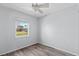 Spare bedroom featuring a window, wood-look flooring, and light blue walls at 112 Gause Dr, Venice, FL 34293