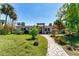 Charming single-story home featuring a landscaped front yard and inviting walkway leading to the entrance at 112 Gause Dr, Venice, FL 34293