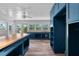 View of kitchen with center island, butcher block counters, ceiling fan, and stainless steel appliances at 112 Gause Dr, Venice, FL 34293