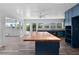 A kitchen featuring butcher block center island, white shiplap ceiling and bright light from multiple windows at 112 Gause Dr, Venice, FL 34293