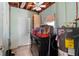 Utility room with open ceiling, laundry machines, water heater and storage at 112 Gause Dr, Venice, FL 34293