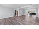 An open-concept living room and view to the kitchen and wood floors at 112 Gause Dr, Venice, FL 34293