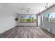 Living room with windows, ceiling fan, wood-look flooring, and natural light at 112 Gause Dr, Venice, FL 34293