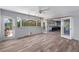 View of living room, showing the wood look flooring and view through the door into the kitchen at 112 Gause Dr, Venice, FL 34293