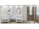 Modern bathroom featuring double vanities, sleek mirrors, and a walk-in shower at 11416 Carlton Fields Dr, Riverview, FL 33579