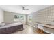 Inviting bedroom with bright natural light, desk space, and hardwood floors at 11416 Carlton Fields Dr, Riverview, FL 33579