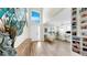 Bright foyer features an open floor plan, hardwood floors, neutral paint, and a modern art piece at 11416 Carlton Fields Dr, Riverview, FL 33579