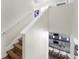 Stairway view down into the modern kitchen with granite countertops and white barstools at 11416 Carlton Fields Dr, Riverview, FL 33579