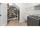 Laundry room with modern appliances, storage, and custom shoe storage off to the side at 11416 Carlton Fields Dr, Riverview, FL 33579