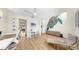 Bright living room with an open floor plan, hardwood floors, neutral paint, high ceilings and art piece at 11416 Carlton Fields Dr, Riverview, FL 33579