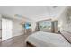 The large main bedroom boasts bright windows, wood flooring, and neutral wall colors at 11416 Carlton Fields Dr, Riverview, FL 33579