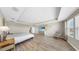 A spacious main bedroom boasting wood floors, a tray ceiling, and decorative wall art at 11416 Carlton Fields Dr, Riverview, FL 33579