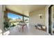 Covered outdoor patio with ample seating and views of the lush greenery and lake at 11416 Carlton Fields Dr, Riverview, FL 33579