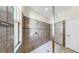 Walk-in shower with tiled walls, mosaic accents, a glass door, and white tile flooring at 11416 Carlton Fields Dr, Riverview, FL 33579