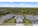 The aerial view showcases the houses in the community, their lush surroundings, and a beautiful lake at 12408 Palatka Dr, Venice, FL 34293