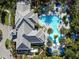 An aerial view of community pool area with lush palms, lounge chairs, and shaded areas, a true paradise at 12408 Palatka Dr, Venice, FL 34293