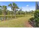 Beautiful backyard features lush landscaping, a pond, and serene views at 12408 Palatka Dr, Venice, FL 34293