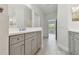 Bathroom features a vanity with grey cabinets, modern fixtures, and tile flooring at 12408 Palatka Dr, Venice, FL 34293