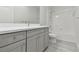 Bathroom featuring a shower-tub combo with gray vanity, white countertop, and gray floors at 12408 Palatka Dr, Venice, FL 34293
