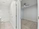 Bedroom with ceiling fan and connected bathroom with a shower-tub combo at 12408 Palatka Dr, Venice, FL 34293