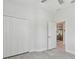 Bedroom with tile floors and an open doorway to the kitchen and a closet at 12408 Palatka Dr, Venice, FL 34293
