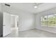 Bedroom with tile floors, bright windows and access to an ensuite bathroom at 12408 Palatka Dr, Venice, FL 34293